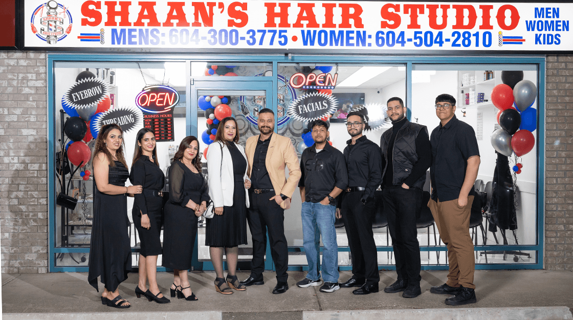 Shaan's Hair Studio team members standing outside their Abbotsford salon storefront during grand opening celebration
