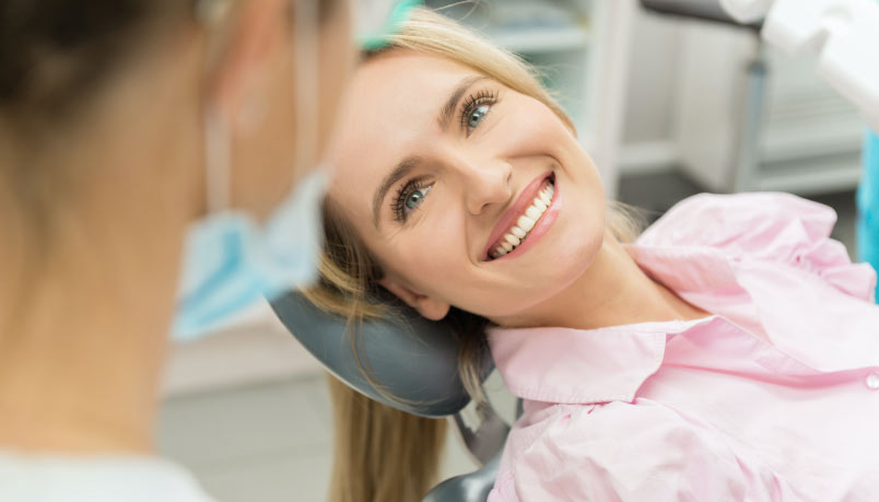 Happy patient smiling in dental chair during IV sedation procedure at Blossom Dental Care in Abbotsford