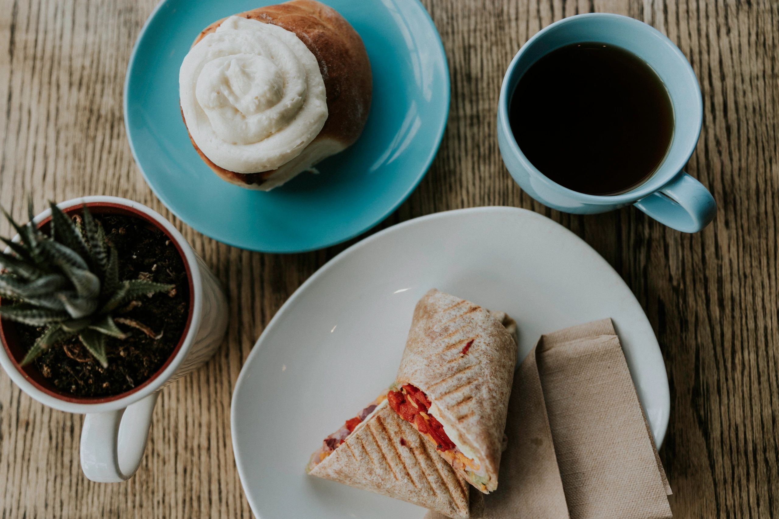 Cinnamon bun, coffee and a panini wrap at Hugs in a Mug Coffee Bistro in Abbotsford
